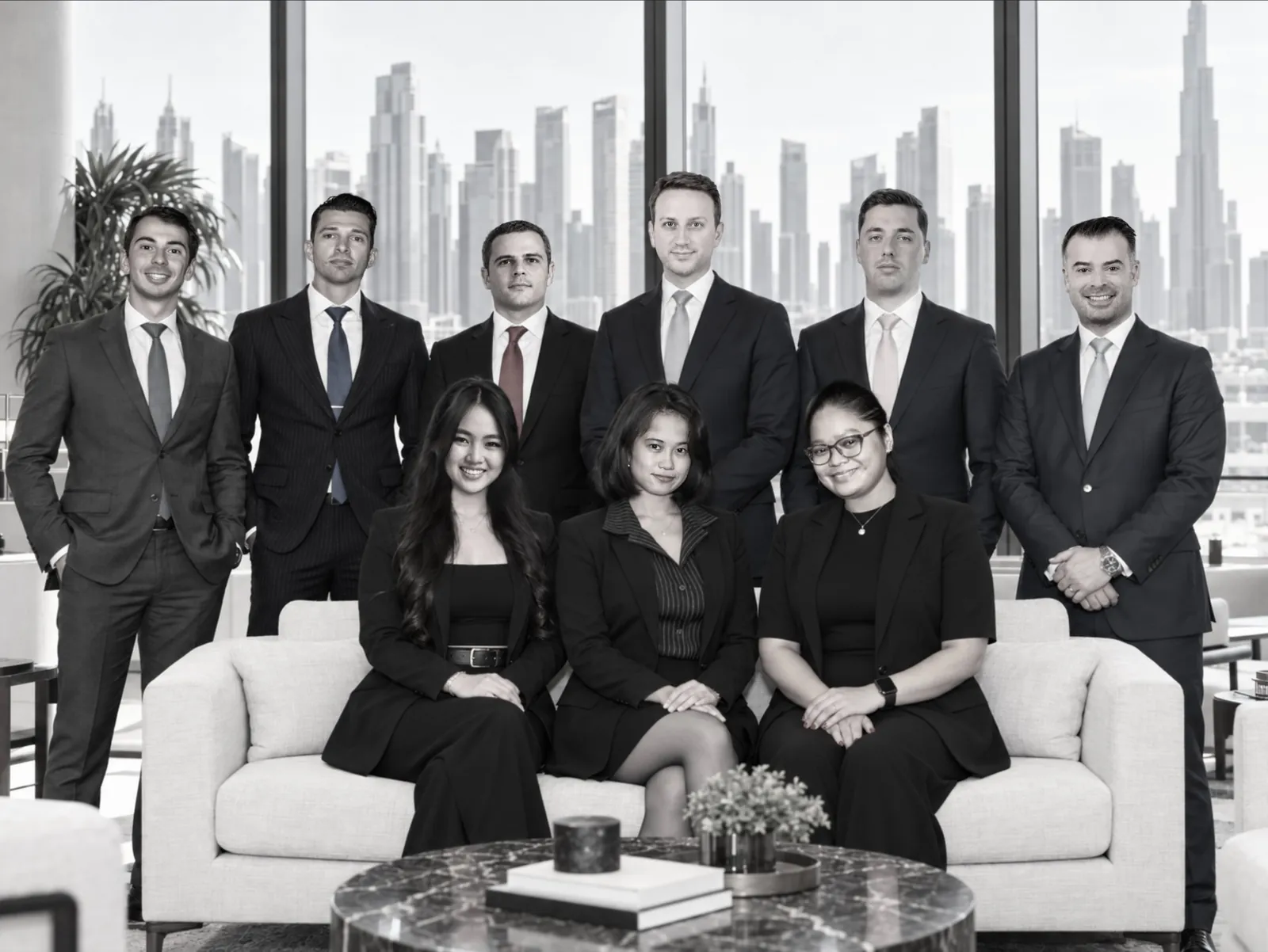 Hexagone Group Dubai team portrait in the Dubai office with the skyline visible behind them